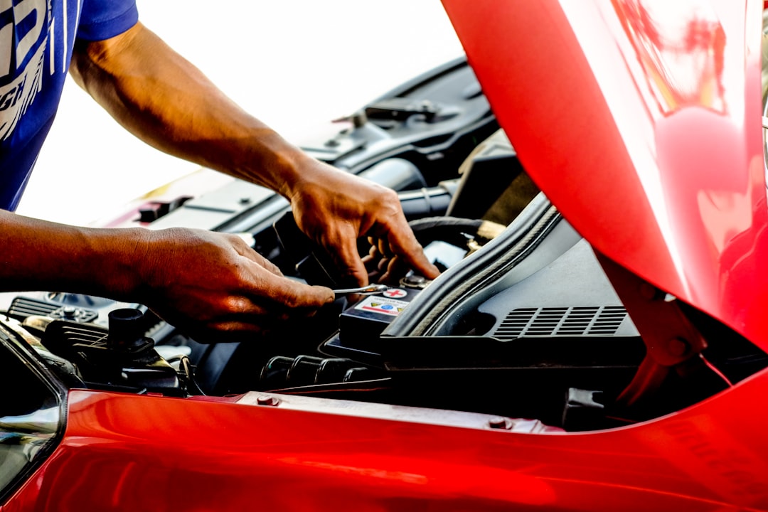 DIY car inspection checklist, mechanic checking engine under hood, car maintenance 2026