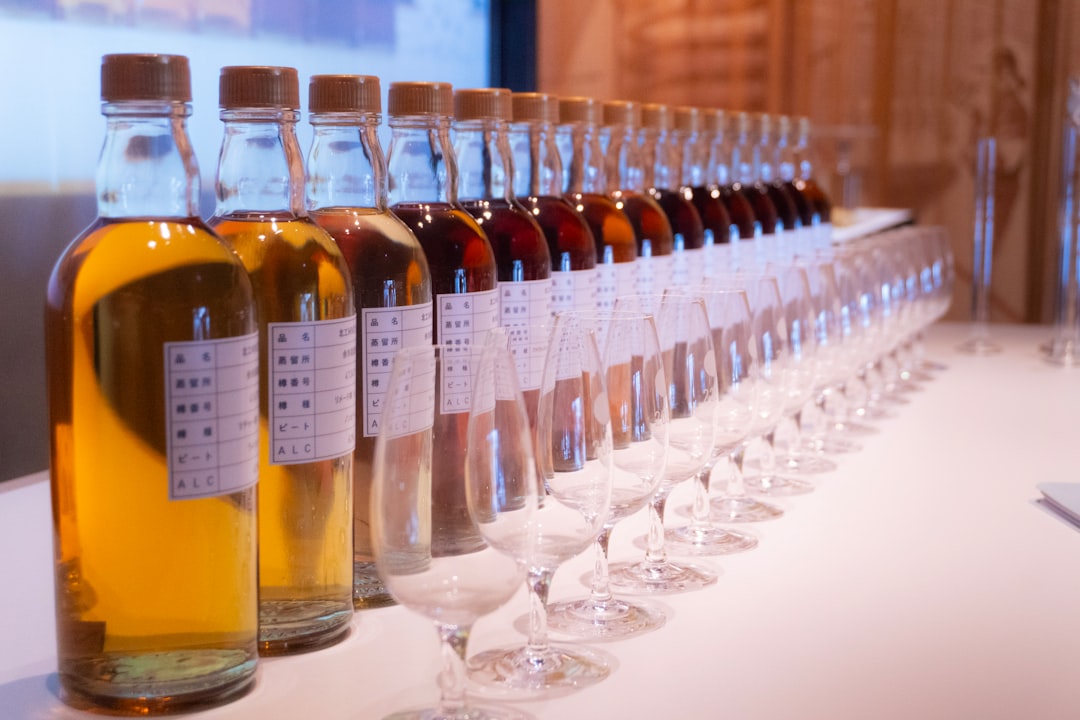 single malt whisky bottles lineup, whisky tasting glass amber