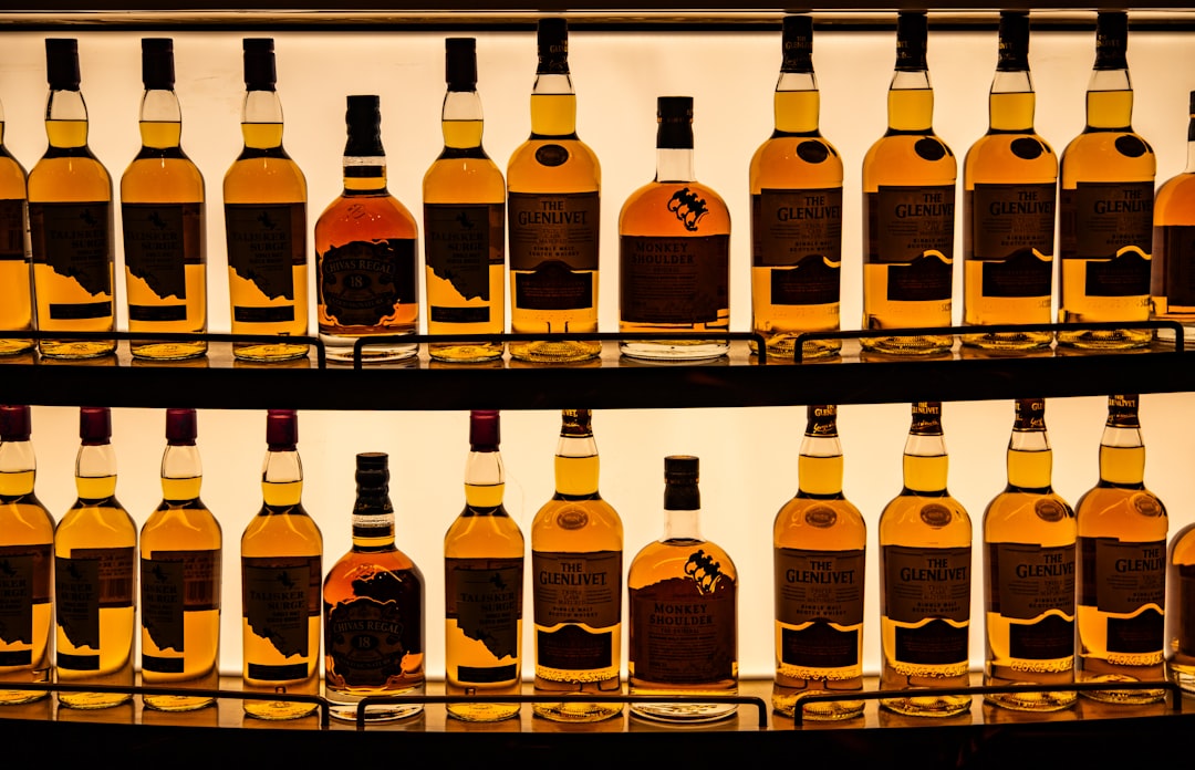 single malt whisky bottles lineup, Scottish distillery golden hour